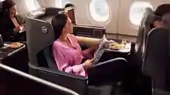 A woman onboard a Qantas plane in business class