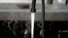 Water running from a modern kitchen tap faucet