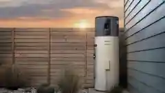 A Rinnai heat pump hot water system installed outside a house against a wooden fence.