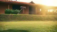 Young family sitting together on the lawn in their backyard