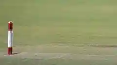 A cricketer batting in front of the stumps