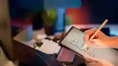 A person's hand using a stylus to check boxes on a digital tablet checklist.