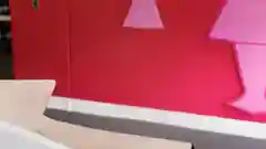 A woman sits by her computer in front of the BCA Pink wall at the Red Energy office 