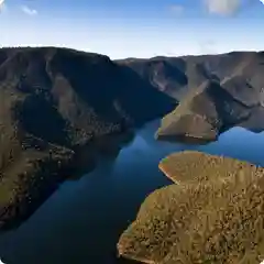 Aerial view of a forested mountain lake in the Snowy Mountains