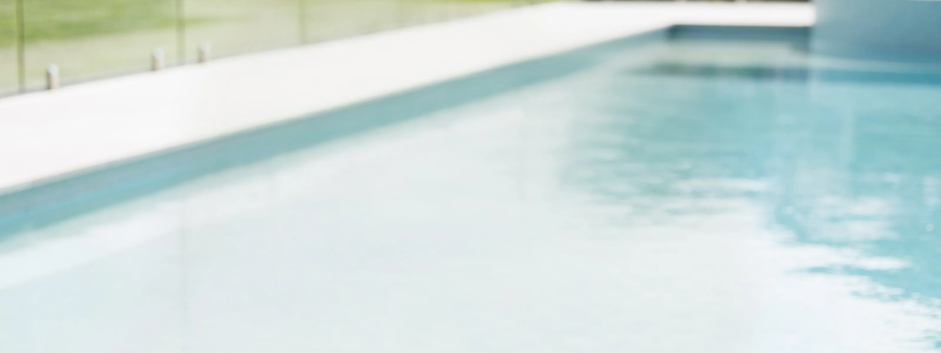 A woman sits by the poolside on holiday